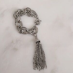 Silver chain link bracelet with tassel detail.